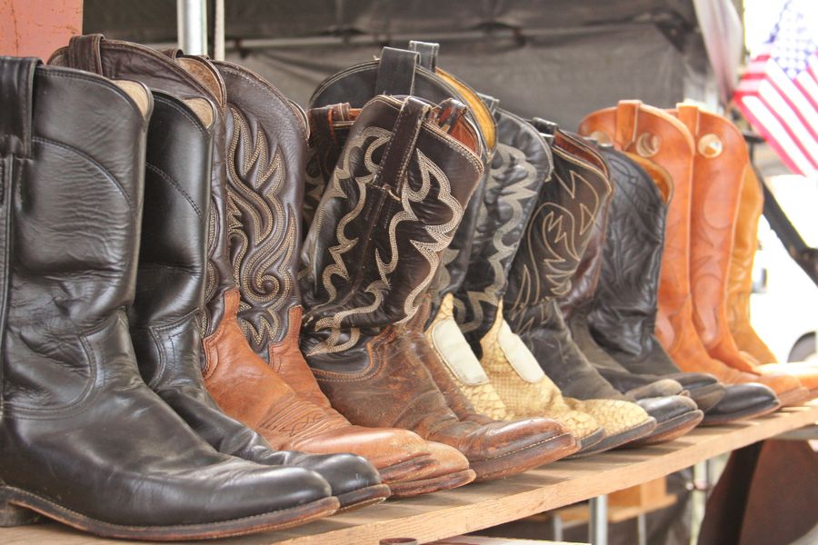 Row of leather cowboy boots on a shelf